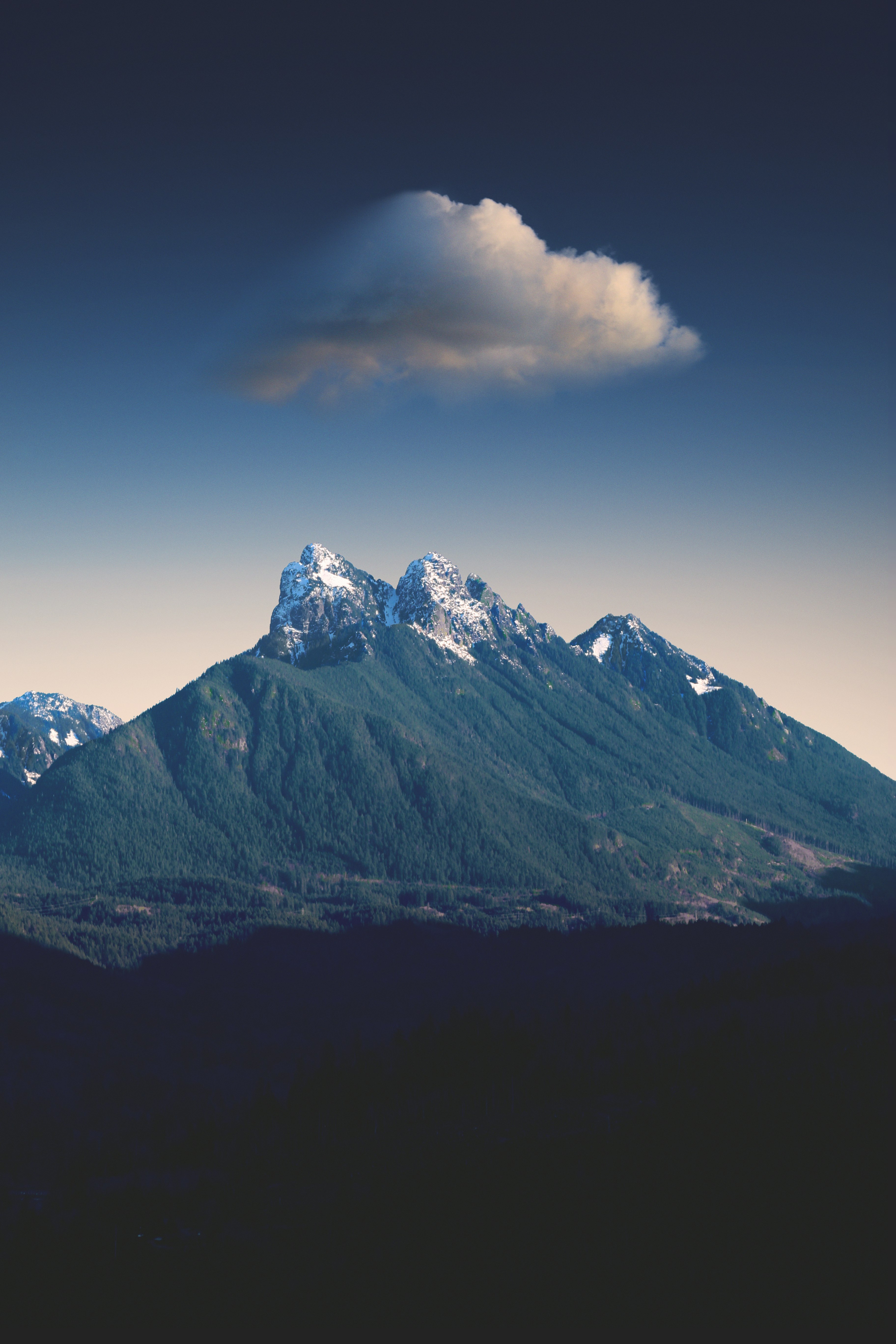 green mountain under white clouds during daytime